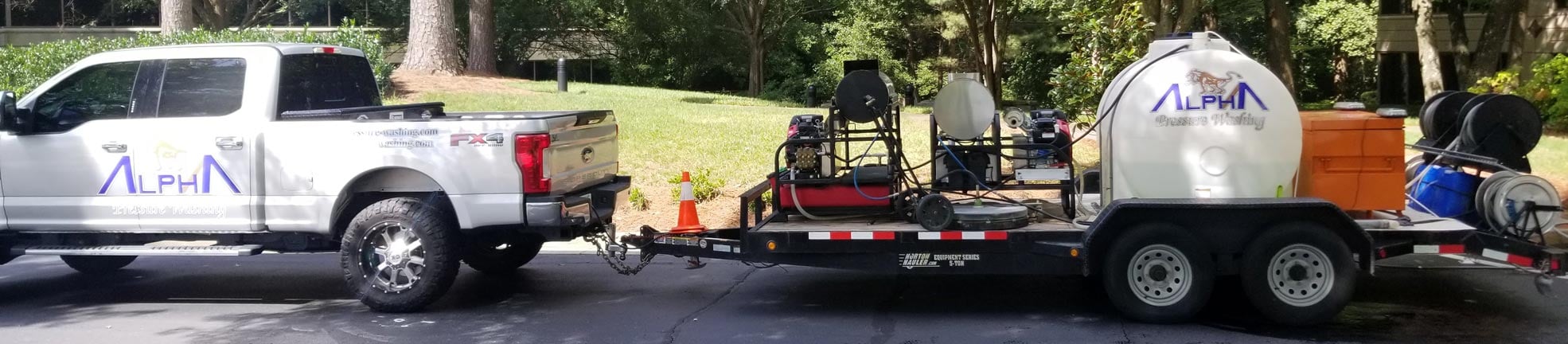 Swimming pool deck, stained on one side and cleaned on the other, with an Alpha Pressure Washing truck at the edge (2018)