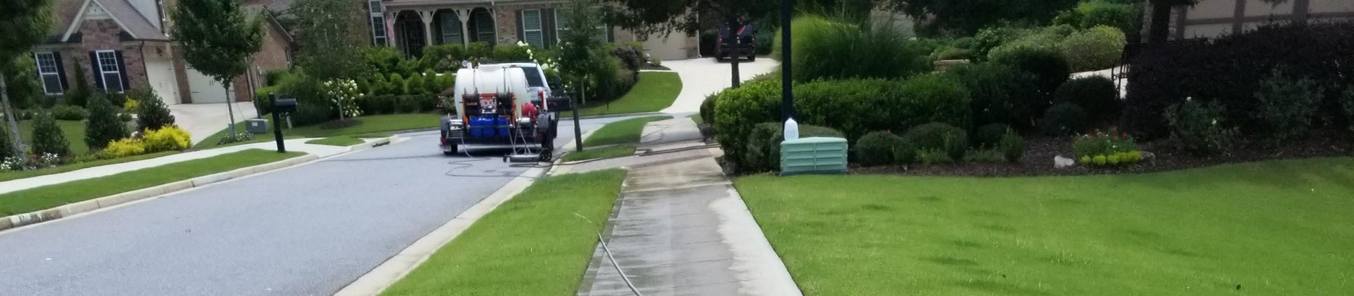 Alpha Pressure Washing truck and enclosed trailer parked in a concrete driveway (2018)