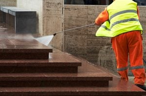 a man washing exterior steps