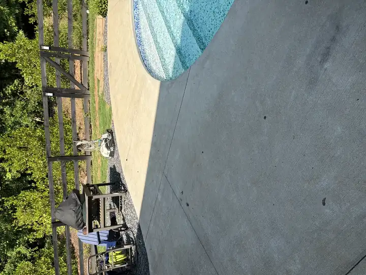 Concrete pool deck prior to cleaning in Canton, GA in partial shadow. you can see the discoloration strongly contrast in direct sunlight.