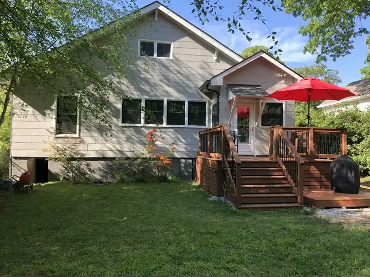 Wood deck and gray siding on a residential home in East Point, GA after soft washing and deck cleaning by Alpha Pressure Washing.