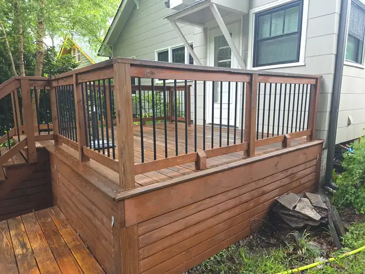 Clean wood deck with railing and skirting boards after pressure washing at a residential home in East Point, GA