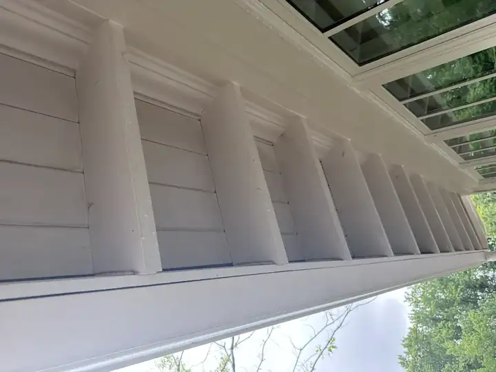 Bright white porch soffit and exposed beams after soft wash house washing on a Marietta, GA home