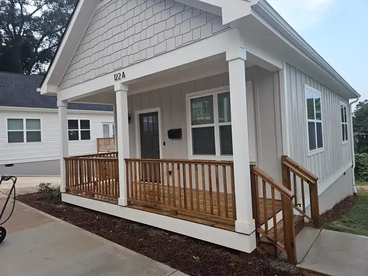 Front porch and wood deck railing on a newly constructed cottage-style home at a pressure washing job in Atlanta, GA.