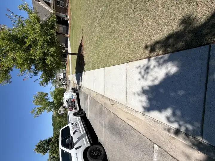 Clean concrete sidewalk after pressure washing with Alpha Pressure Washing truck and trailer at Canton, GA community