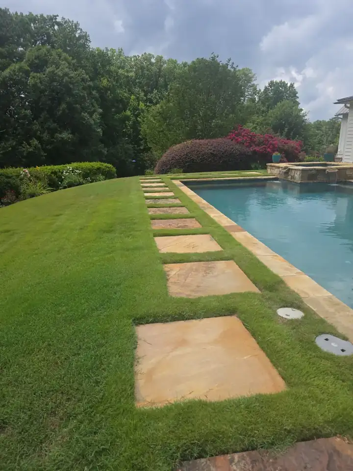 Stone stepping-pad pathway beside a residential pool at a pressure washing job in Milton, GA.