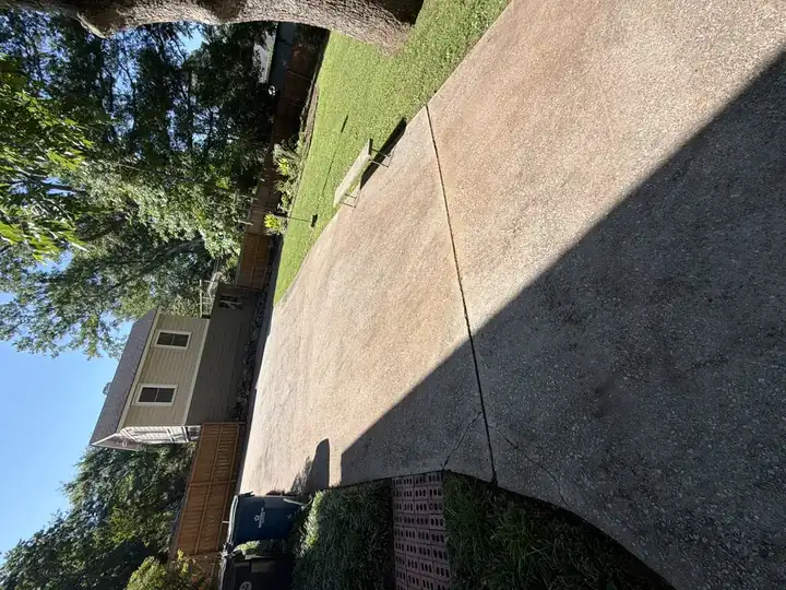 Wide concrete driveway pad looking clean after pressure washing service in East Point, GA