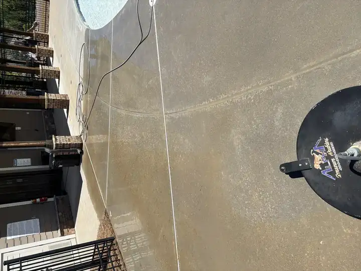 Surface cleaner in action on concrete pool deck mid-wash, showing before-and-after contrast in Canton, GA