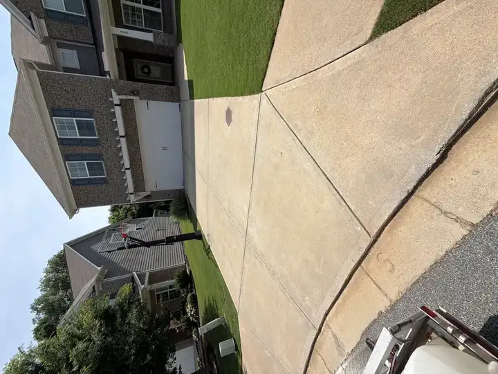 Concrete driveway with rust and organic staining before pressure washing at a Canton, GA home