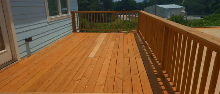 Wood deck with railing on a new construction home at a pressure washing job in Atlanta, GA.