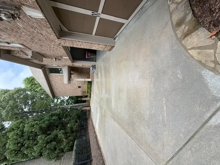 Concrete driveway in front of a two-car garage at a Duluth, GA home before or after pressure washing.