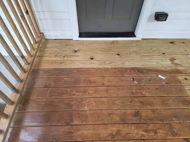 Wood deck boards during pressure washing showing contrast between wet and dry areas at a new construction job in Atlanta, GA.