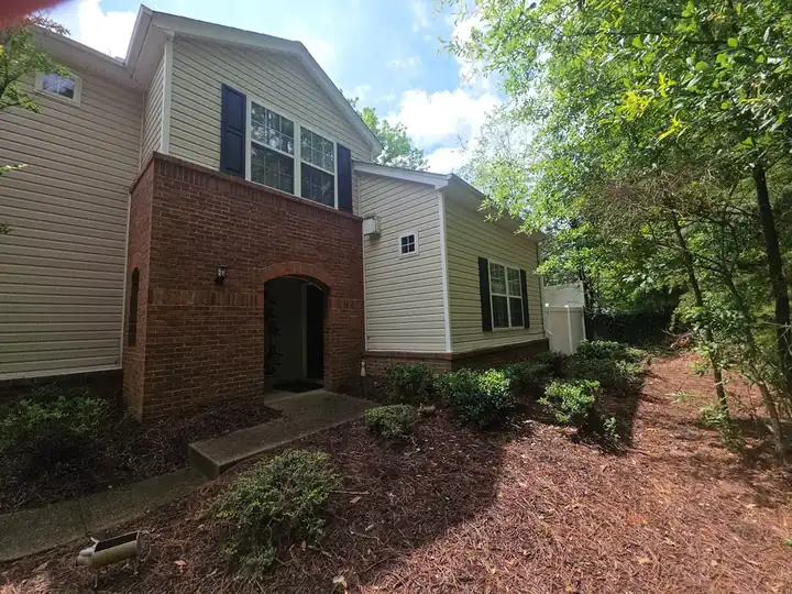 Front of a residential home with brick and vinyl siding at a house washing job in Woodstock, GA.