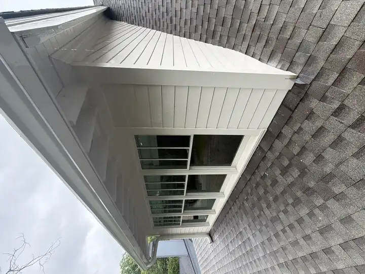 Clean white vinyl siding and porch enclosure exterior after house washing on a Marietta, GA residence