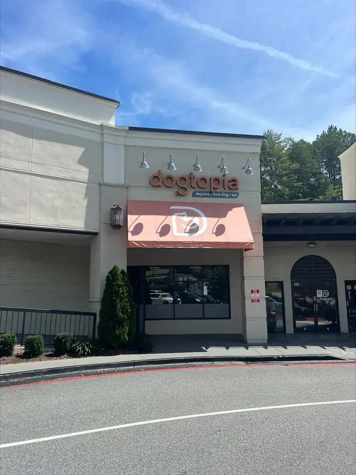 Commercial fabric awning on a retail storefront in Roswell, GA after pressure washing, wide shot showing the full facade.