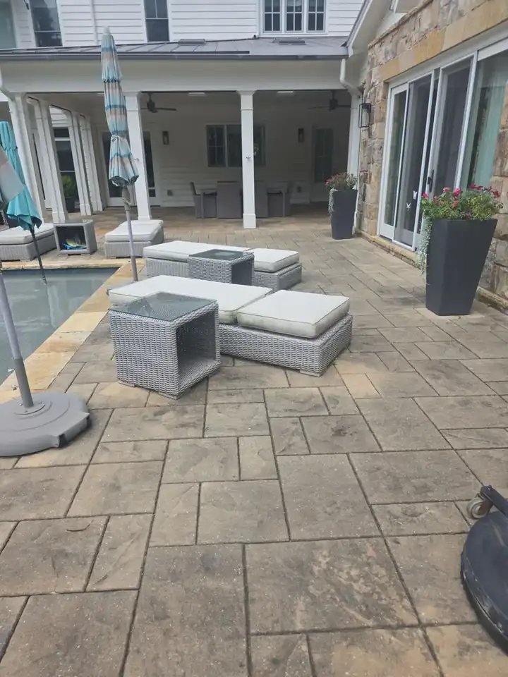 Stamped concrete pool deck with outdoor lounge furniture beside a pool at a Milton, GA residence.