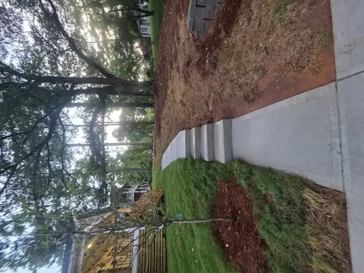 Concrete walkway with steps descending a slope after a new construction pressure washing job in Atlanta, GA.