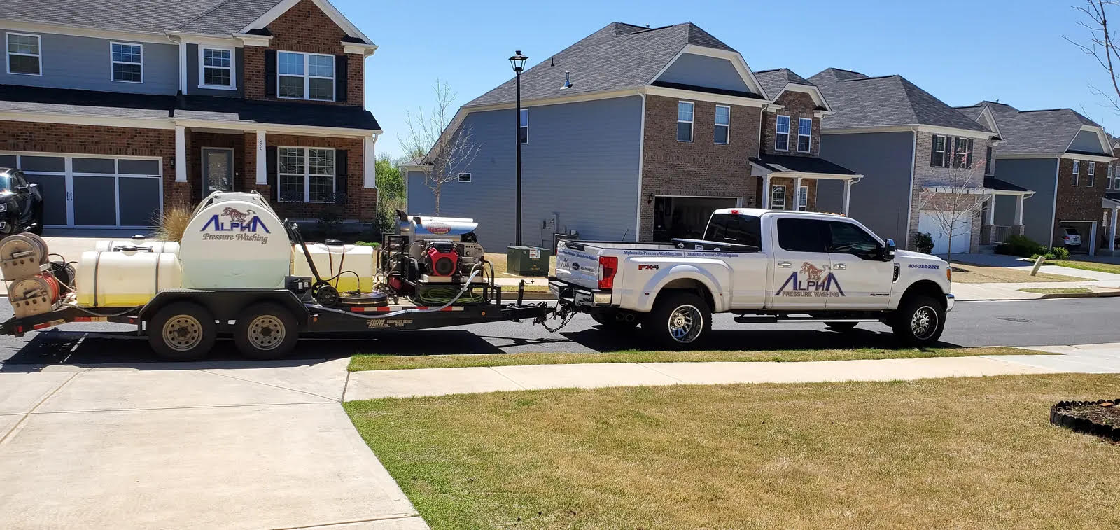 Alpha Pressure Washing truck and trailer with pressure-washing equipment parked on a residential street