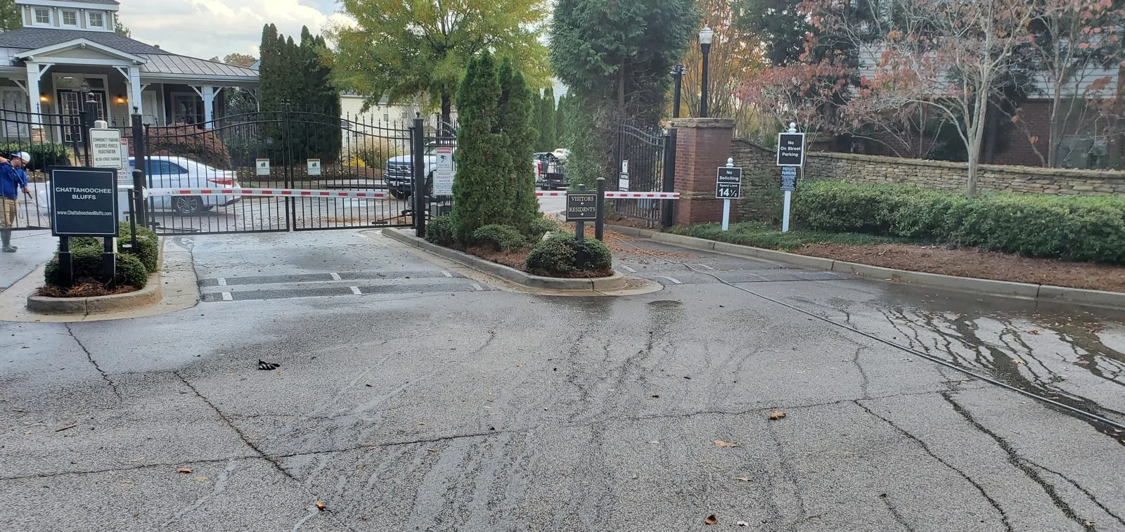 Concrete driveway at Chattahoochee Bluffs after cleaning, with the company truck parked between the houses (November 11, 2021)